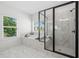 Bathroom with a modern glass shower, soaking tub, and large windows at 1225 Westshore Dr, Cumming, GA 30041