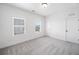 A bright bedroom with neutral carpet, white walls, and two large windows at 1225 Westshore Dr, Cumming, GA 30041