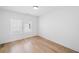 Bedroom with hardwood floors, white walls, and two windows at 1225 Westshore Dr, Cumming, GA 30041