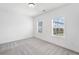A well-lit bedroom with carpeting and a large window at 1225 Westshore Dr, Cumming, GA 30041