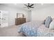 Bedroom featuring carpet, neutral walls, a dresser, and view to ensuite bath at 1225 Westshore Dr, Cumming, GA 30041