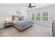 Bedroom with a ceiling fan, plush carpet, and large windows with natural light at 1225 Westshore Dr, Cumming, GA 30041