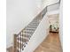 Bright entryway showcasing a staircase with wooden handrails, hardwood floors, and a glimpse into the dining area at 1225 Westshore Dr, Cumming, GA 30041