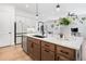 Open kitchen with a large island, stainless steel appliances, pendant lights and hardwood flooring at 1225 Westshore Dr, Cumming, GA 30041