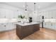 Modern kitchen featuring white cabinets, a dark wood island with marble countertops, and stainless steel appliances at 1225 Westshore Dr, Cumming, GA 30041