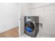 Laundry room with marble floors, a modern washer, and shelving for storage at 1225 Westshore Dr, Cumming, GA 30041