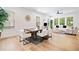Open-concept living and dining area featuring light hardwood floors, modern decor, and plenty of natural light at 1225 Westshore Dr, Cumming, GA 30041