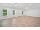 Spacious living room featuring new herringbone floors and modern lighting with natural light at 1225 Westshore Dr, Cumming, GA 30041