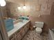 Bathroom with patterned tile, a large mirror, and updated toilet and vanity at 1810 Trophy Dr, Marietta, GA 30062