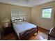 Cozy bedroom features hardwood floors, windows and comfortable bed at 1810 Trophy Dr, Marietta, GA 30062