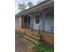 Close up of the front porch with brick steps, decorative posts, and gray painted ceiling at 1810 Trophy Dr, Marietta, GA 30062
