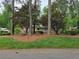View of the home from the street showcasing mature landscaping at 1810 Trophy Dr, Marietta, GA 30062