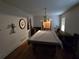 Game room with a large pool table covered in plastic, hardwood floors, and vintage lighting at 1810 Trophy Dr, Marietta, GA 30062