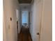 Hallway with hardwood floors and white doors, including a view of the adjacent room at 1810 Trophy Dr, Marietta, GA 30062