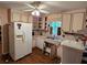 A kitchen featuring vintage-style patterned cabinets, white appliances, and dual sinks at 1810 Trophy Dr, Marietta, GA 30062