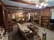 Spacious living room with brick fireplace, wood paneling, and an adjacent dining area at 1810 Trophy Dr, Marietta, GA 30062