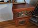 Close-up of a vintage-style radio with a wood cabinet, display, and retro knobs at 1810 Trophy Dr, Marietta, GA 30062