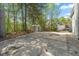 Backyard with a storage shed and basketball hoop surrounded by mature trees, providing a secluded recreational area at 2055 Deans Landing Dr, Lawrenceville, GA 30043