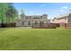 Large backyard featuring a spacious lawn, a deck, and privacy fence at 2055 Deans Landing Dr, Lawrenceville, GA 30043