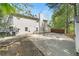 Backyard featuring a basketball hoop, a storage shed, and a wooded backdrop, perfect for outdoor activities at 2055 Deans Landing Dr, Lawrenceville, GA 30043