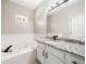 Bathroom features a soaking tub with white tile and gray vanity at 2055 Deans Landing Dr, Lawrenceville, GA 30043