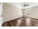 Bright bedroom with wood floors, a ceiling fan, and views of the backyard at 2055 Deans Landing Dr, Lawrenceville, GA 30043