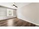 Bright bedroom with wood floors, a ceiling fan, and custom built-in bookshelves at 2055 Deans Landing Dr, Lawrenceville, GA 30043