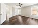 Bedroom with hardwood floors, neutral paint, access to the hallway, an exterior door, and two windows at 2055 Deans Landing Dr, Lawrenceville, GA 30043