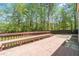 Outdoor deck with built-in seating overlooks a wooded area at 2055 Deans Landing Dr, Lawrenceville, GA 30043