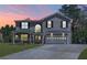 Charming two-story brick home featuring a covered porch, attached two-car garage, and well-maintained front lawn at 2055 Deans Landing Dr, Lawrenceville, GA 30043