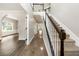 Elegant foyer featuring a staircase, hardwood floors, and an arched doorway leading to adjacent rooms at 2055 Deans Landing Dr, Lawrenceville, GA 30043