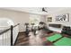 Upstairs workout area featuring hardwood floors, exercise equipment, and natural light from the window at 2055 Deans Landing Dr, Lawrenceville, GA 30043