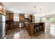 Modern kitchen with stainless steel appliances, dark wood cabinets, counter seating, and access to outdoor deck at 2055 Deans Landing Dr, Lawrenceville, GA 30043