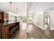 Open-concept kitchen featuring a breakfast bar, pendant lighting, stainless steel appliances, and seamless access to the living area at 2055 Deans Landing Dr, Lawrenceville, GA 30043