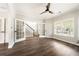 Bright living room boasts hardwood floors, a ceiling fan, and ample natural light at 2055 Deans Landing Dr, Lawrenceville, GA 30043