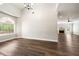 Spacious living room with hardwood floors, arched window, and adjacent fireplace at 2055 Deans Landing Dr, Lawrenceville, GA 30043