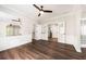 Living room shows hardwood floors, a decorative mirror, ceiling fan, and white trim at 2055 Deans Landing Dr, Lawrenceville, GA 30043