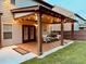 A house featuring a covered back patio with string lights and outdoor seating at 2435 Sentinel Chase Way, Cumming, GA 30041