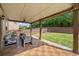A covered back patio with outdoor seating, overlooking the backyard at 2435 Sentinel Chase Way, Cumming, GA 30041