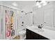 Bathroom with a shower-tub combo and a dark vanity with a white sink at 2435 Sentinel Chase Way, Cumming, GA 30041