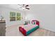Bright bedroom featuring hardwood floors, a ceiling fan, and a large window at 2435 Sentinel Chase Way, Cumming, GA 30041