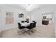 Elegant dining room with modern lighting, wainscoting, hardwood floors, and a view into the kitchen at 2435 Sentinel Chase Way, Cumming, GA 30041