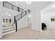 Open foyer with hardwood floors, black railing staircase, white walls, and a view of the entry at 2435 Sentinel Chase Way, Cumming, GA 30041