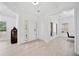 Bright foyer with hardwood floors, white walls, a view of the entry door, and a side room at 2435 Sentinel Chase Way, Cumming, GA 30041