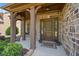 Inviting front porch with stone columns, a brick facade, and a decorative front door with sidelights at 2435 Sentinel Chase Way, Cumming, GA 30041