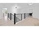 Hallway showing hardwood floors, black railings, and neutral paint at 2435 Sentinel Chase Way, Cumming, GA 30041