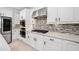 A view of the kitchen showcasing white cabinets and stainless steel appliances at 2435 Sentinel Chase Way, Cumming, GA 30041