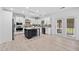Bright kitchen with white cabinets, stainless steel appliances, a dark island, and wood-style floors at 2435 Sentinel Chase Way, Cumming, GA 30041