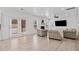 A bright living room with french doors, a fireplace, and hardwood floors at 2435 Sentinel Chase Way, Cumming, GA 30041