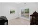 Cozy office space with natural light, a hanging chair, decor, and light hardwood floors at 2435 Sentinel Chase Way, Cumming, GA 30041